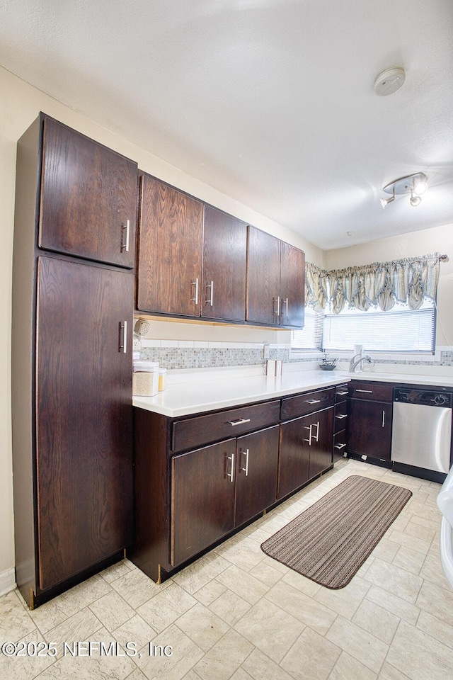 kitchen featuring dark brown cabinets, dishwasher, and light countertops