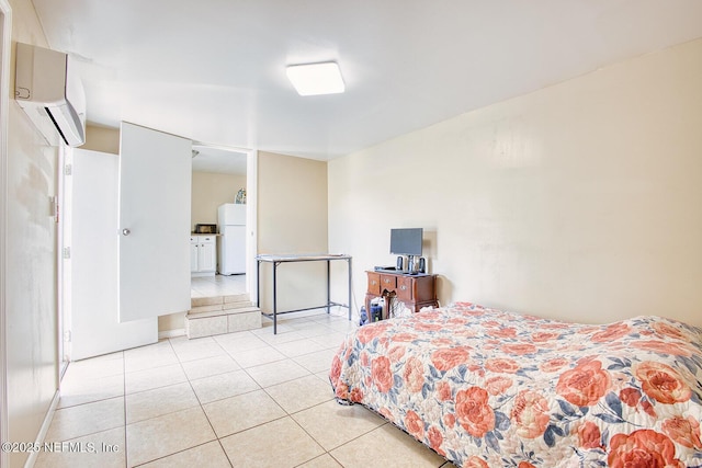 bedroom with light tile patterned flooring, a wall mounted AC, and freestanding refrigerator