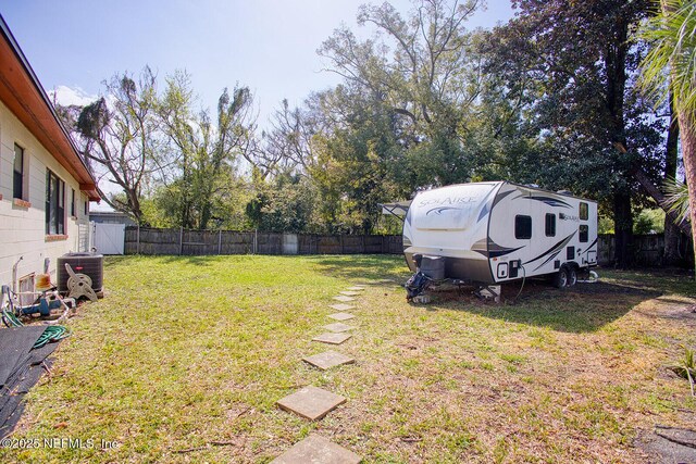 view of yard featuring central AC and a fenced backyard