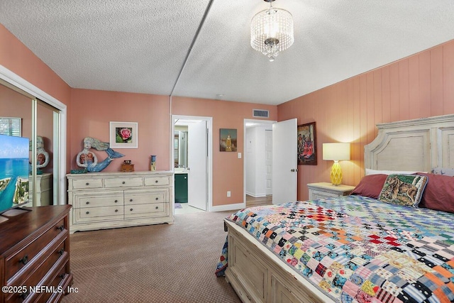 bedroom with visible vents, a textured ceiling, a closet, and carpet flooring