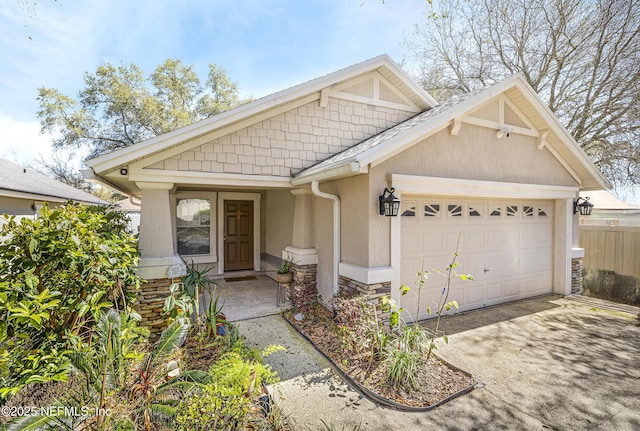 view of front of house featuring stone siding, stucco siding, concrete driveway, and a garage