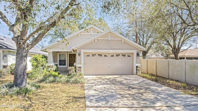 craftsman-style house with stucco siding, driveway, a garage, and fence