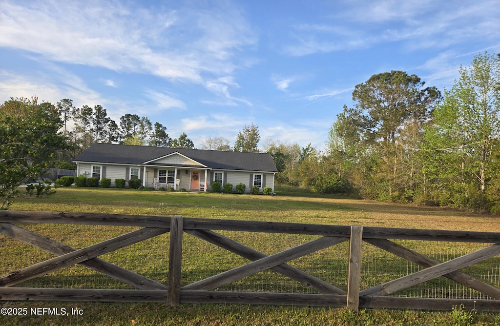 ranch-style home featuring a fenced front yard and a front yard