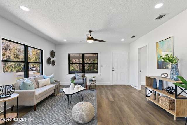 living room with visible vents, recessed lighting, baseboards, and wood finished floors