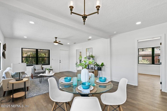 dining area with recessed lighting, plenty of natural light, and wood finished floors