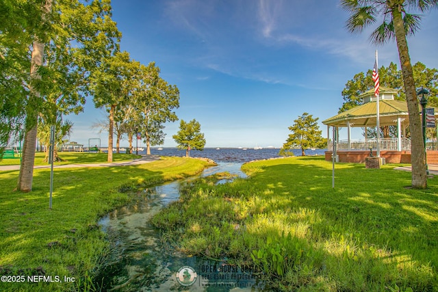 view of yard with a gazebo and a water view