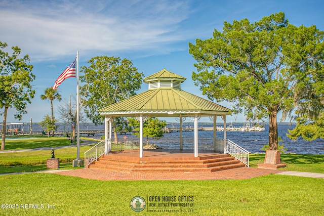 view of community with a gazebo, a yard, and a water view