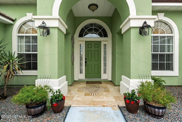 entrance to property with stucco siding