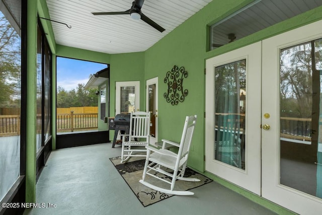 sunroom / solarium featuring french doors and ceiling fan