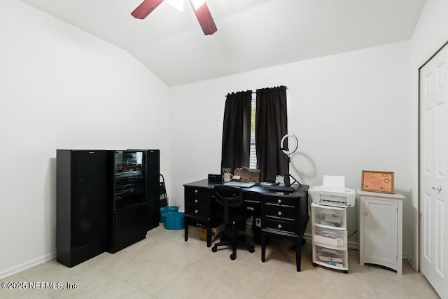 tiled office space with vaulted ceiling and a ceiling fan