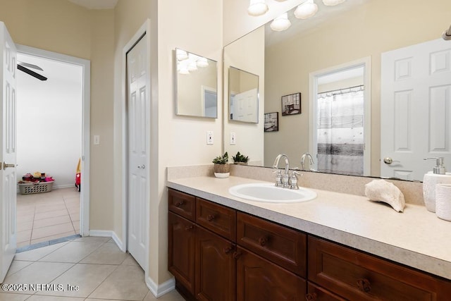 bathroom with tile patterned flooring, vanity, and baseboards