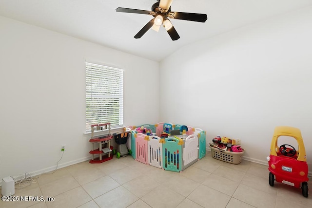 game room featuring tile patterned flooring, vaulted ceiling, baseboards, and ceiling fan