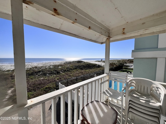 balcony with a view of the beach and a water view