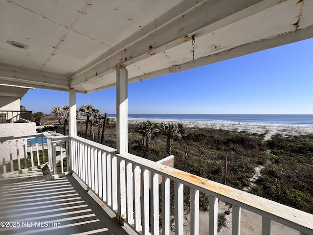 balcony with a view of the beach and a water view