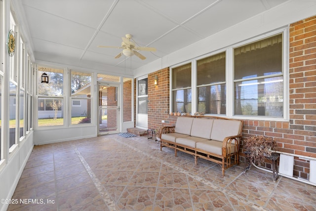 unfurnished sunroom with a ceiling fan