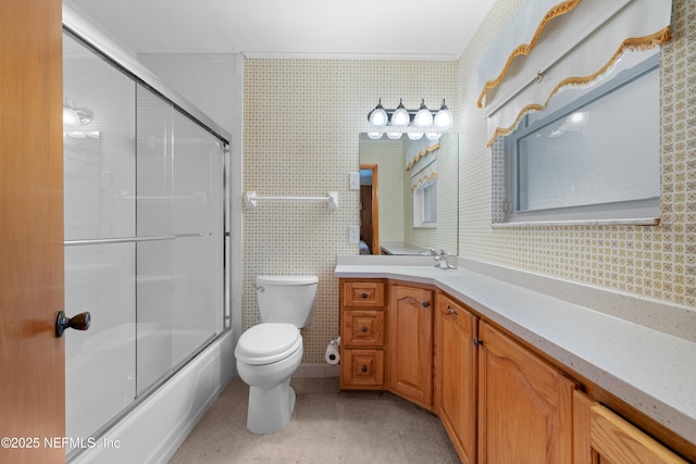 bathroom with wallpapered walls, toilet, and vanity