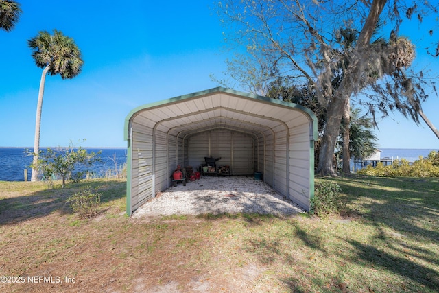 view of outdoor structure with a carport and a water view