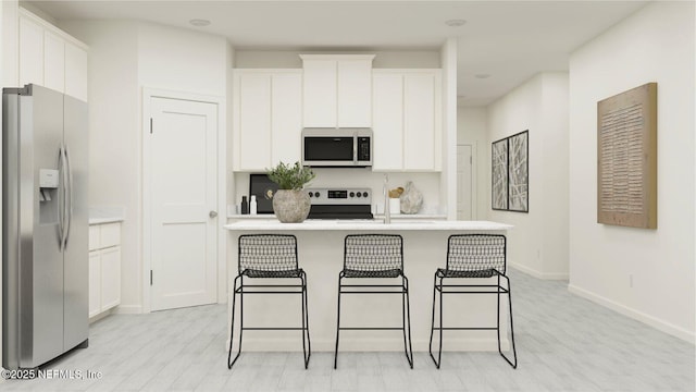 kitchen with electric range, a kitchen bar, white cabinets, and stainless steel refrigerator with ice dispenser