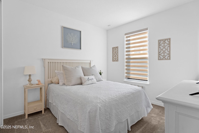 carpeted bedroom featuring baseboards