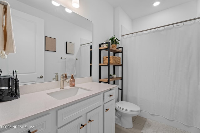 bathroom featuring vanity, toilet, a shower with curtain, and recessed lighting