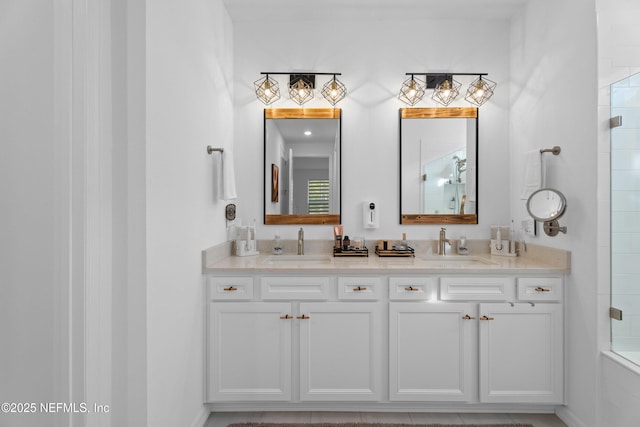 full bathroom with double vanity, a shower, and a sink