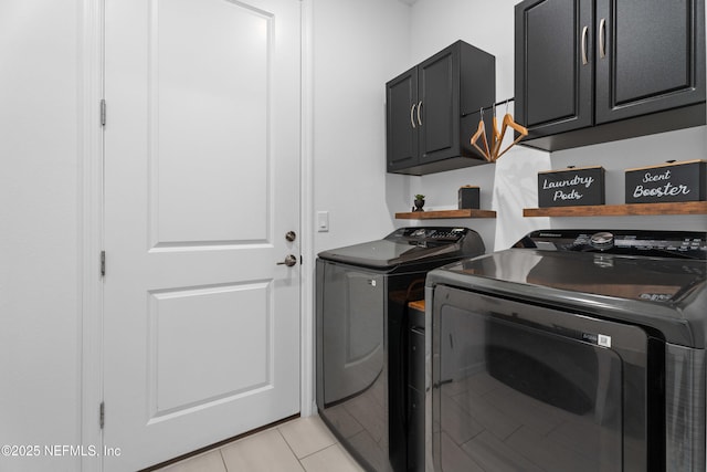 laundry room with washer and dryer, light tile patterned floors, and cabinet space