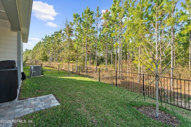 view of yard with central air condition unit and a fenced backyard