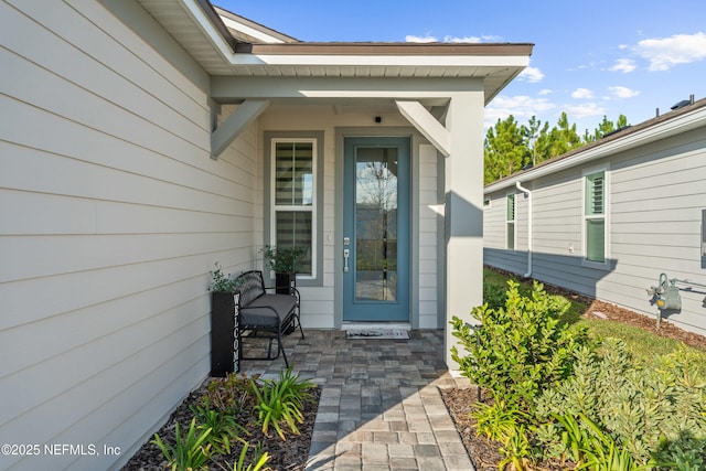 view of exterior entry with a porch