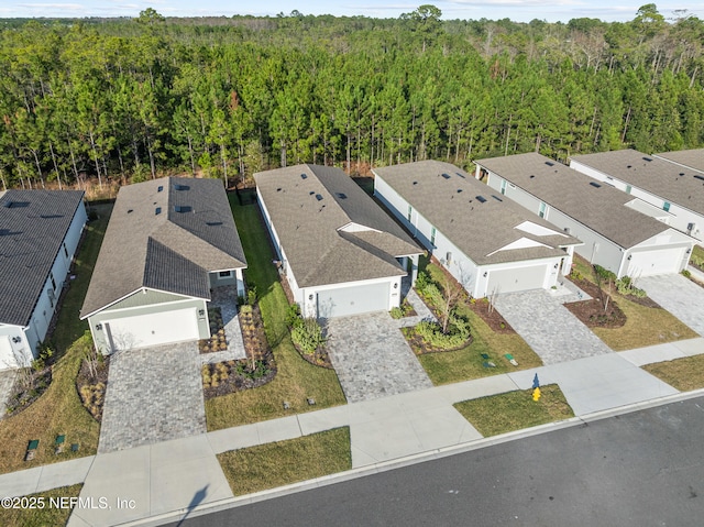 aerial view featuring a forest view and a residential view