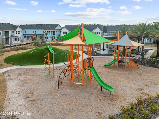 community jungle gym with a residential view and a lawn