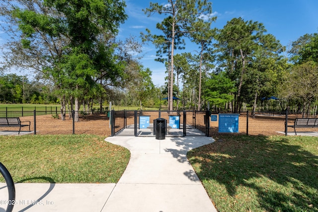 surrounding community featuring a yard and fence