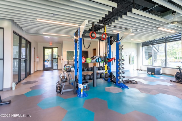 workout area featuring french doors and baseboards