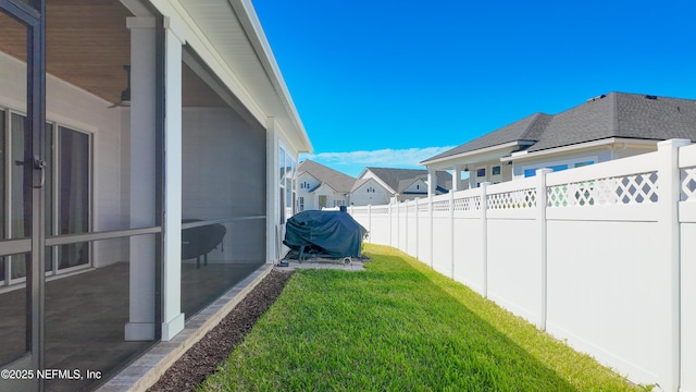 view of yard with a fenced backyard and a residential view