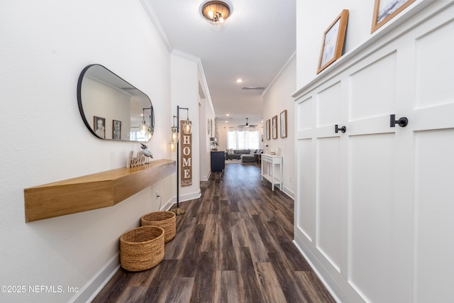 hallway with recessed lighting, crown molding, baseboards, and dark wood-type flooring
