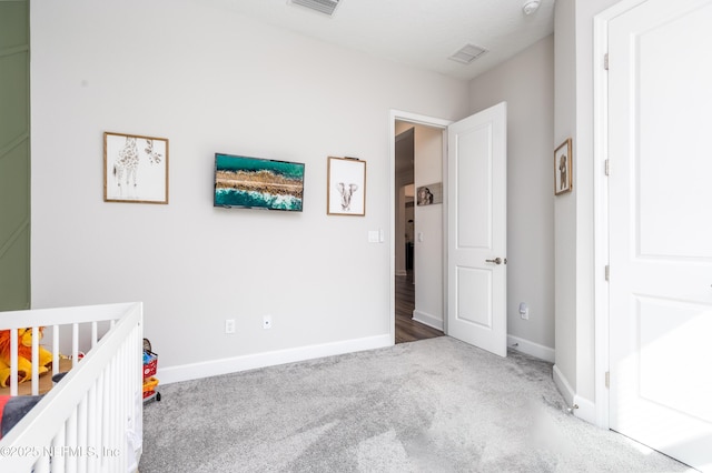 carpeted bedroom with baseboards and visible vents