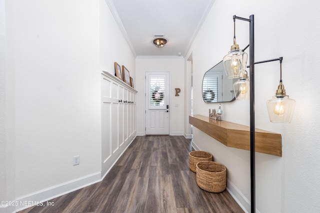 doorway to outside with ornamental molding, dark wood-type flooring, baseboards, and visible vents