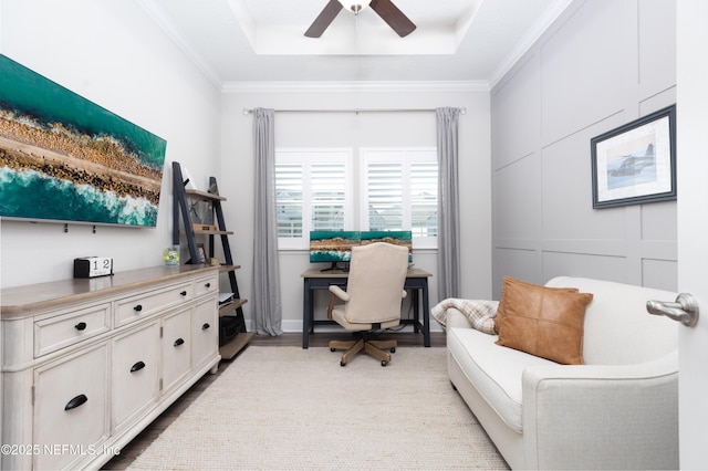 office featuring ornamental molding, wood finished floors, a ceiling fan, and a raised ceiling