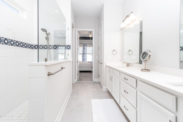 bathroom with tile patterned floors, a sink, ensuite bath, walk in shower, and double vanity