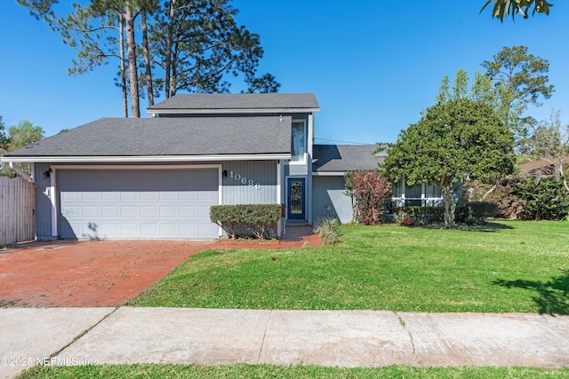 view of front of home with driveway, an attached garage, roof with shingles, and a front lawn