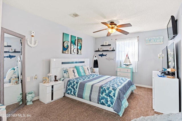 carpeted bedroom featuring visible vents, baseboards, a textured ceiling, and ceiling fan