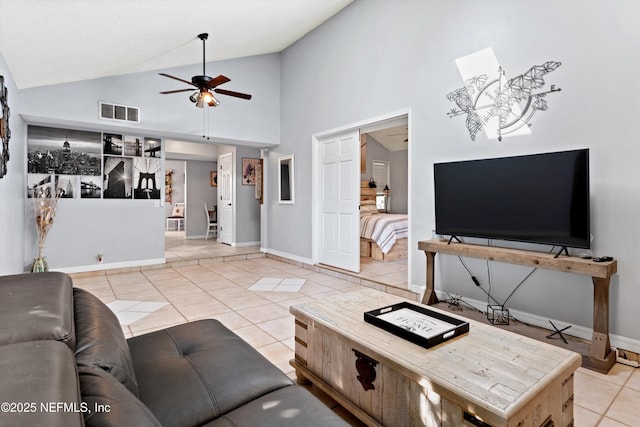 living room featuring light tile patterned floors, visible vents, baseboards, and a ceiling fan