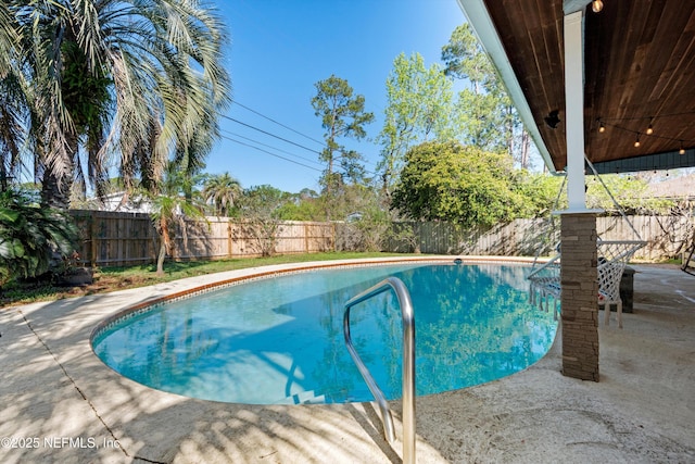 view of pool with a fenced in pool, a fenced backyard, and a patio area