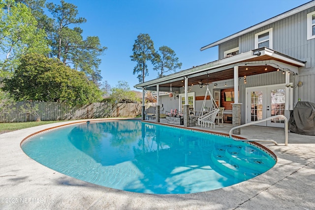 view of pool featuring a patio, french doors, a fenced in pool, and a fenced backyard