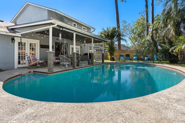 view of pool featuring a fenced in pool, french doors, a patio, and fence