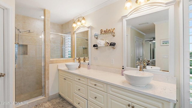 bathroom with a sink, a shower stall, and crown molding