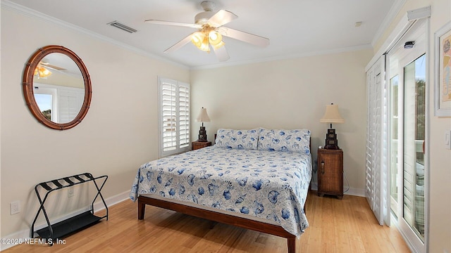 bedroom featuring visible vents, ornamental molding, a ceiling fan, wood finished floors, and baseboards