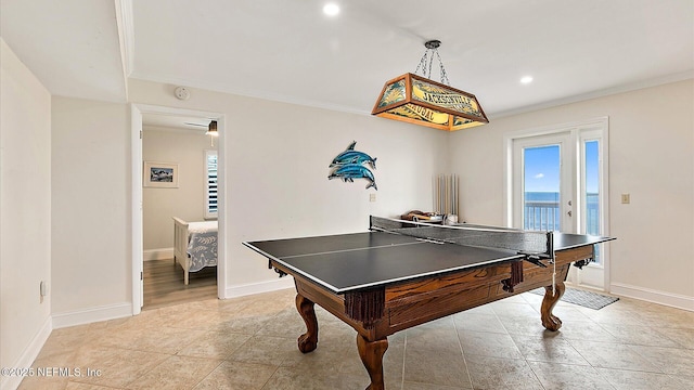 game room featuring light tile patterned floors, baseboards, and ornamental molding