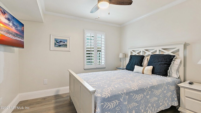 bedroom featuring ceiling fan, dark wood-style floors, baseboards, and ornamental molding