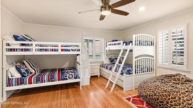 bedroom with crown molding, ceiling fan, and wood finished floors