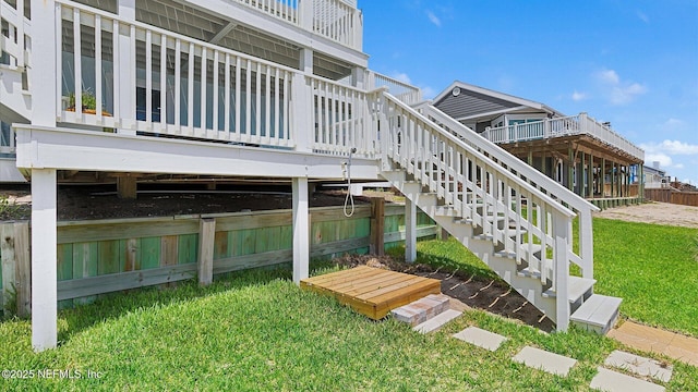 exterior space featuring a yard, a wooden deck, and stairs